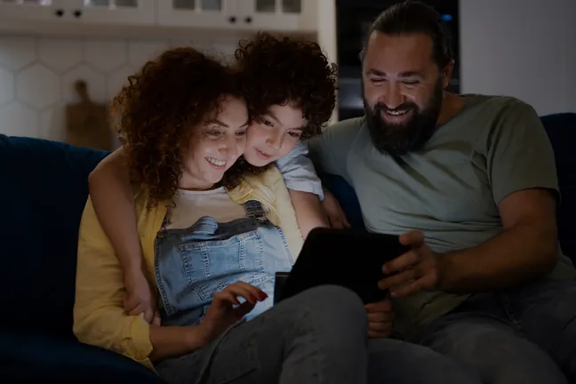 Family streaming an NFHS Network event together on a tablet